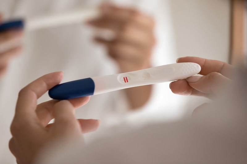 Person holding a positive pregnancy test.