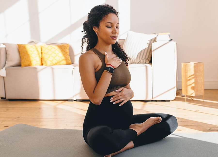 Young pregnant woman meditating