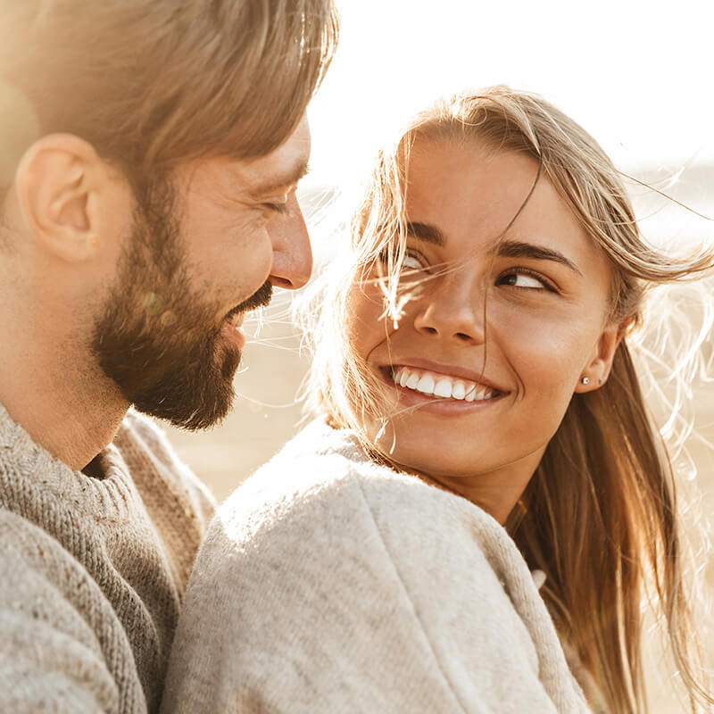 couple smiling in the sun